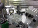 Prototype fixture designed and built for high production, precision 5-axis CNC machining of raw castings for the automotive industry.